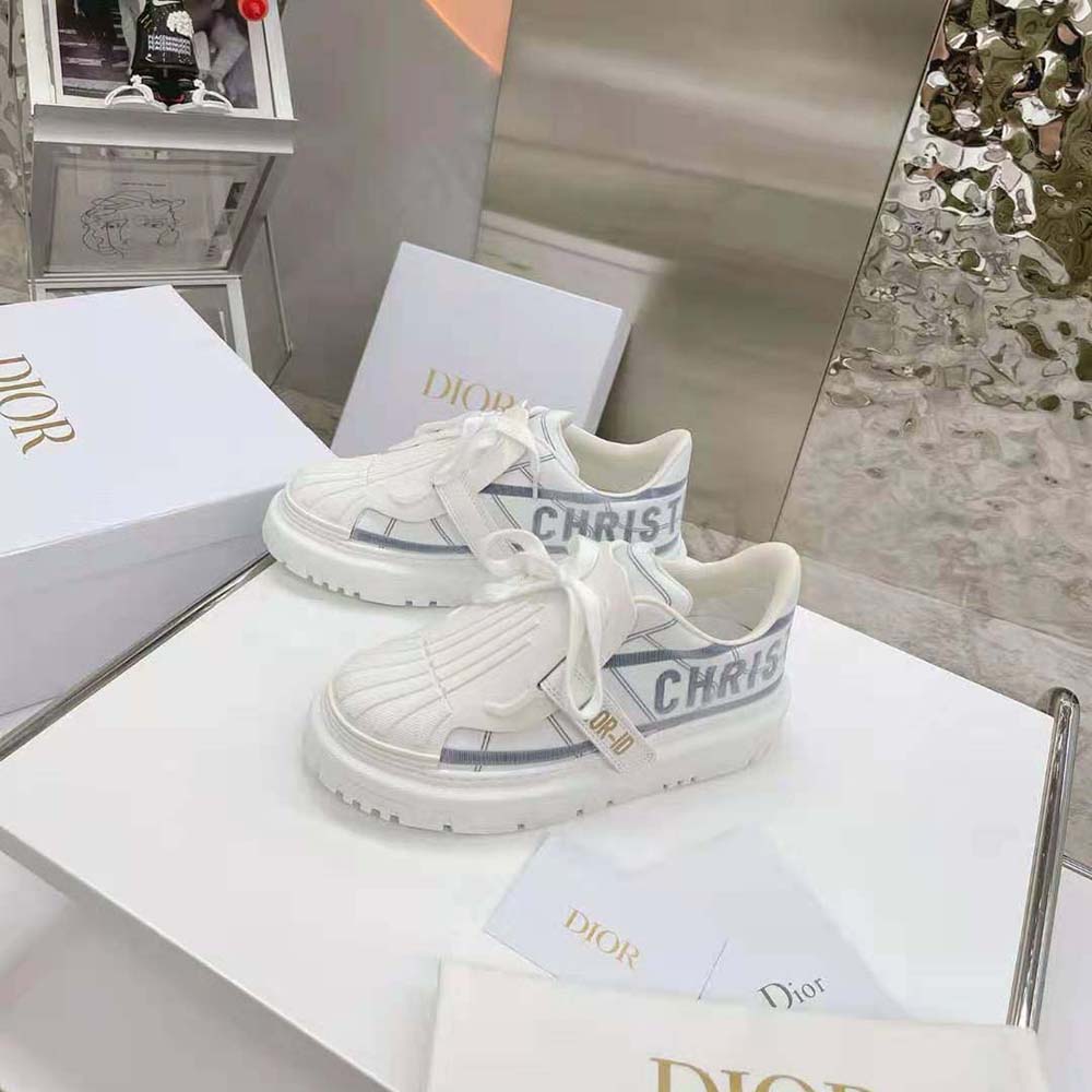 Close-up on Dior hardware and lace-up detail of Dior-id Sneaker