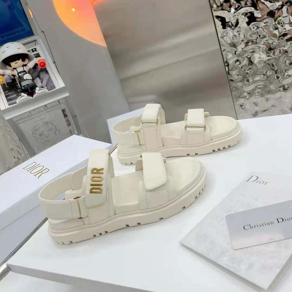 Close-up of white lambskin and silver Dior hardware on Dioract Sandal