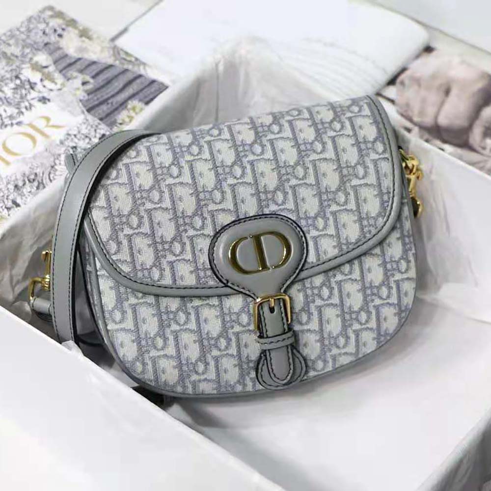 Close-up on the magnetic closure and antique silver hardware of Dior Bobby Bag