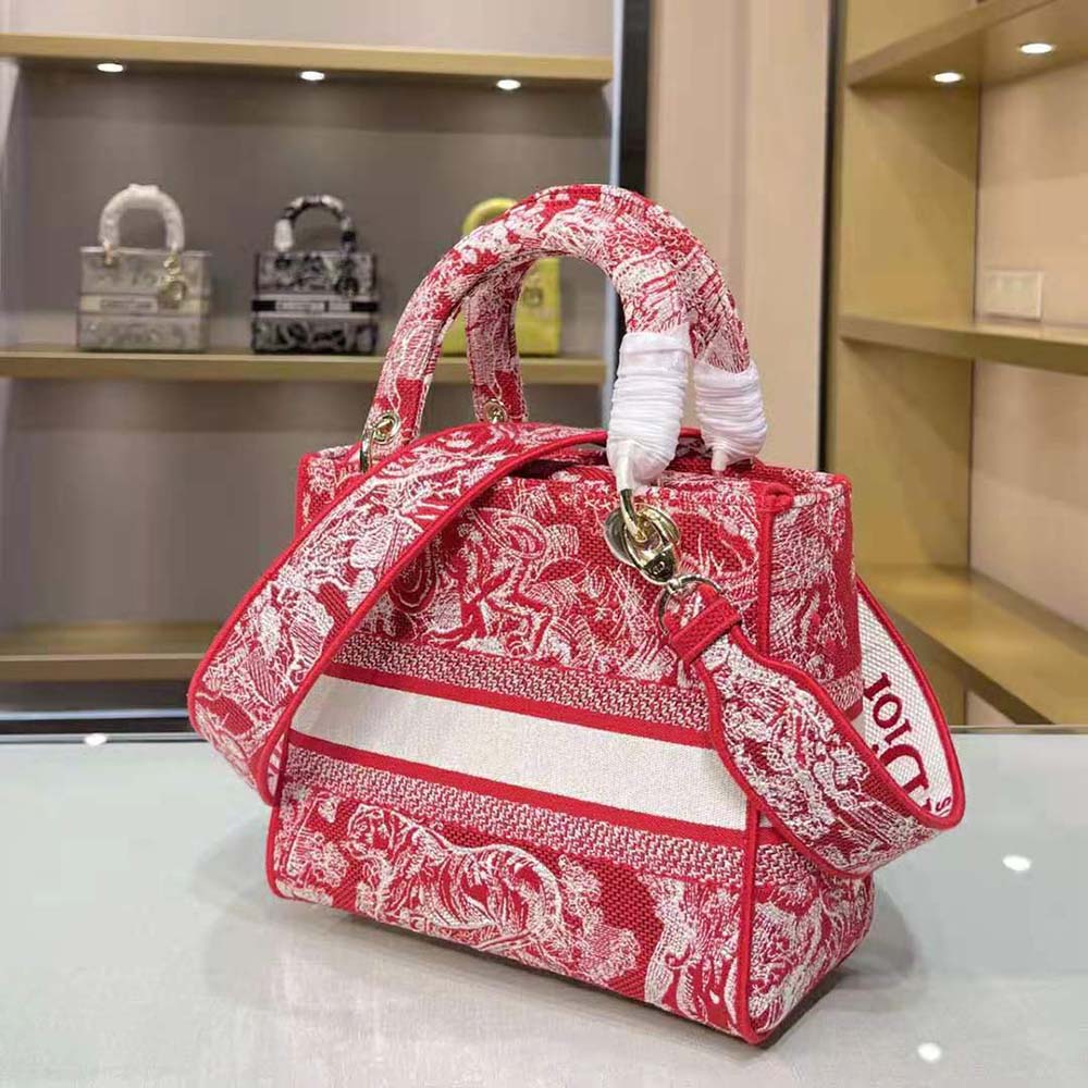 Side angle showing raspberry red toile de Jouy embroidery details