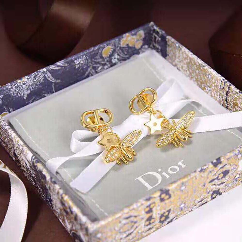 Close-up of white crystal detailing on Dior Women Petit CD Earrings