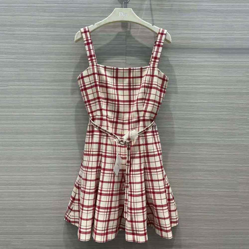 Close-up of signature Dior pop hardware on red check dress