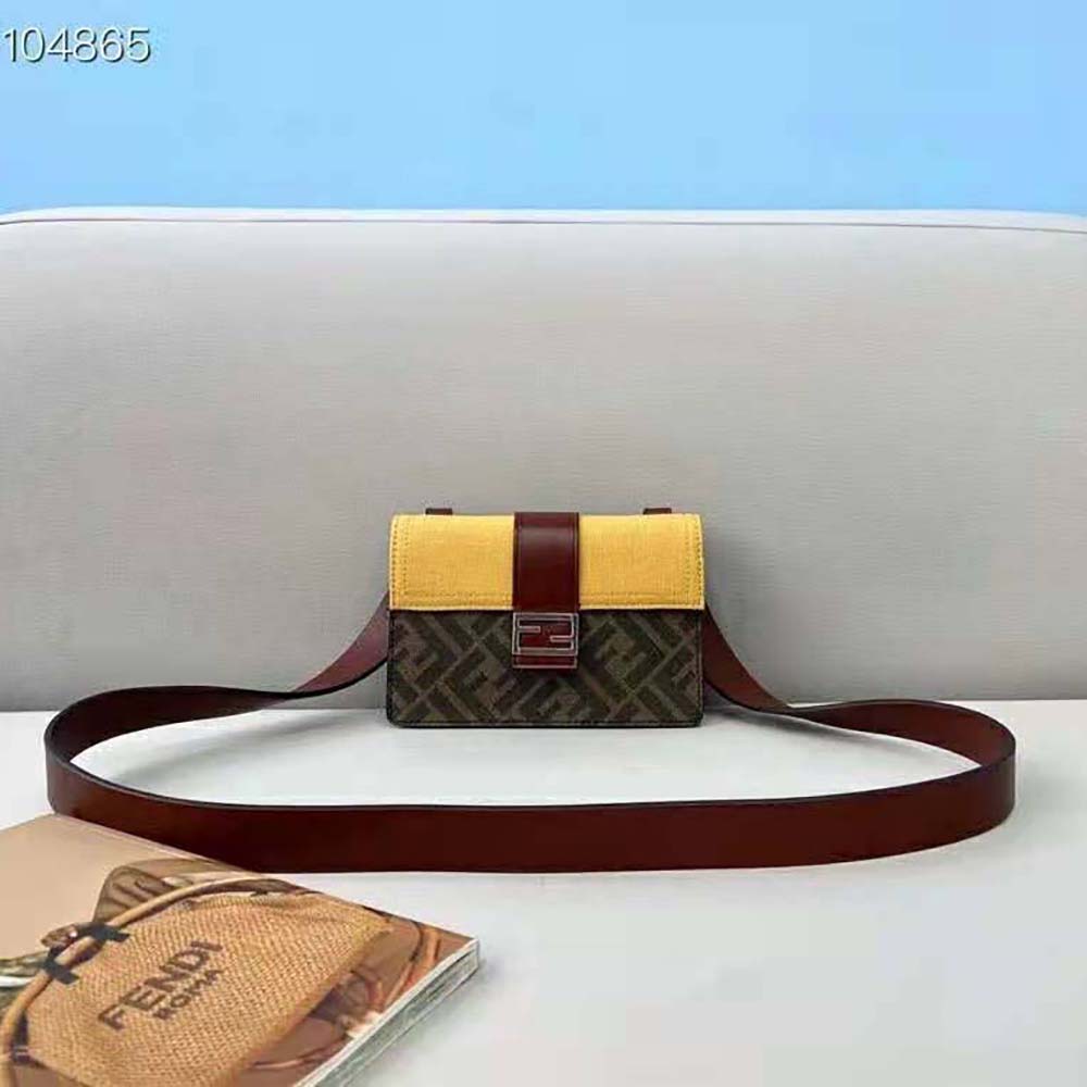 Close-up of gold Fendi logo hardware on yellow fabric bag