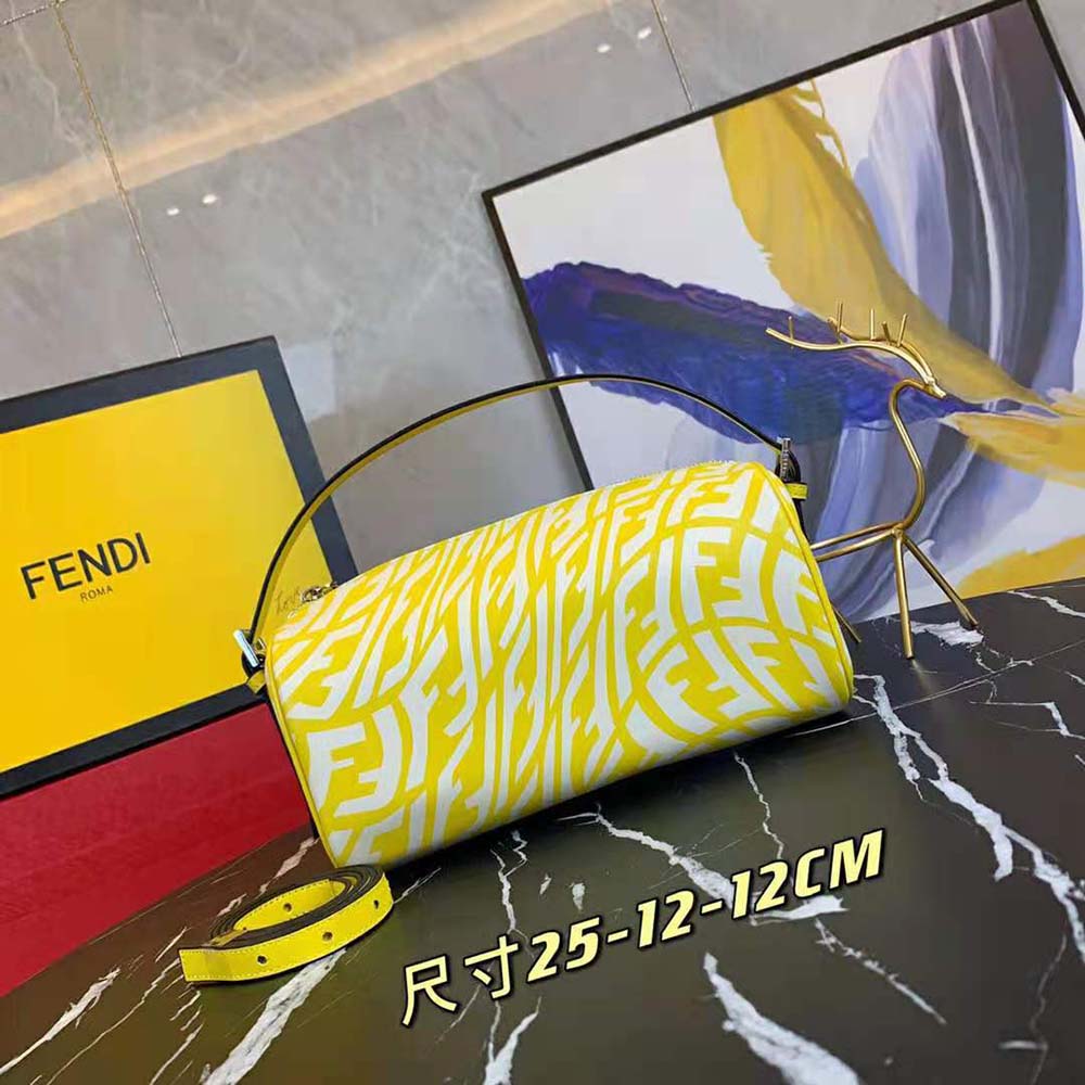 Close-up of signature gold FF logo hardware on yellow mini bag
