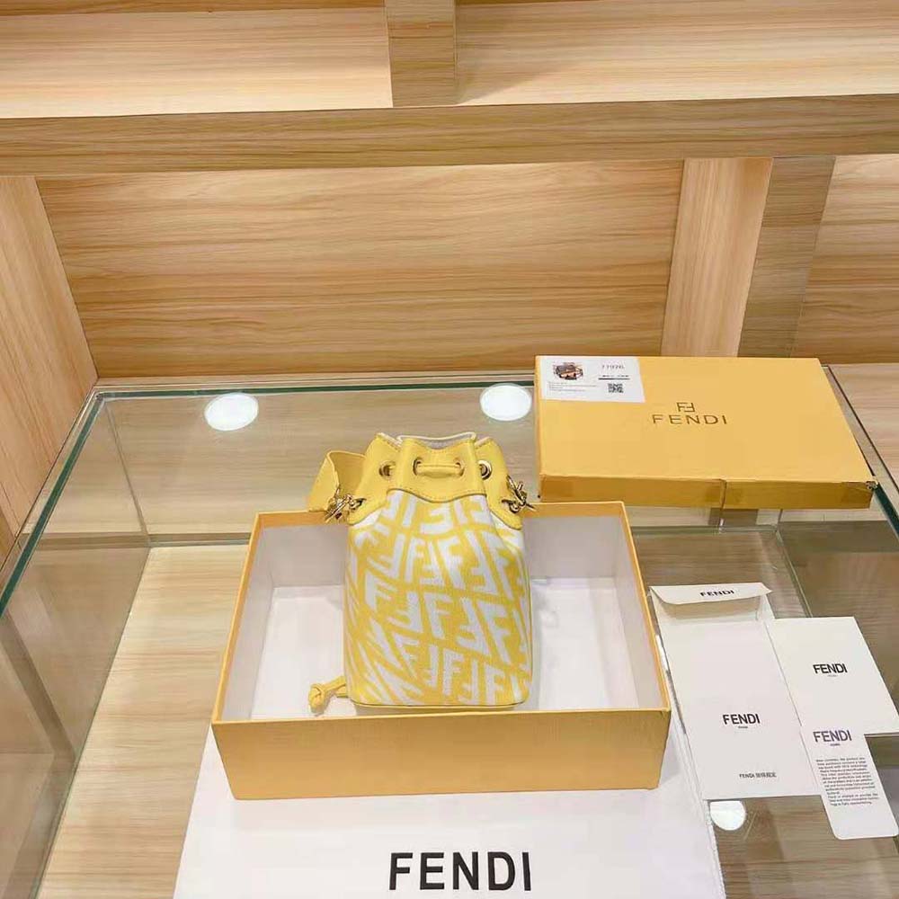 Side angle showing compact silhouette of Fendi yellow mini-bag