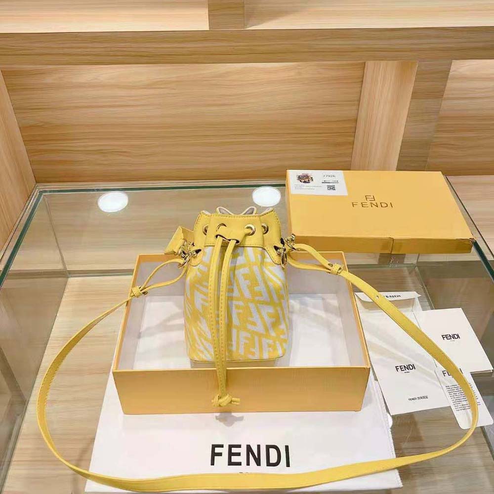 Close-up of gold-tone Fendi logo charm on mini-bag