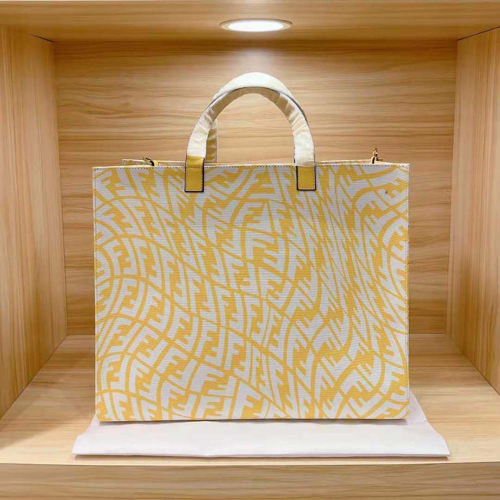 Close-up of glossy yellow glazed canvas and Fendi logo detail