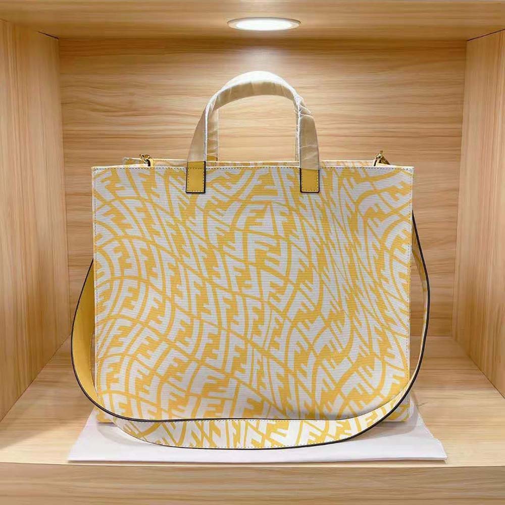 Side angle showing structured silhouette of Fendi Women Shopper Yellow Glazed Canvas Bag