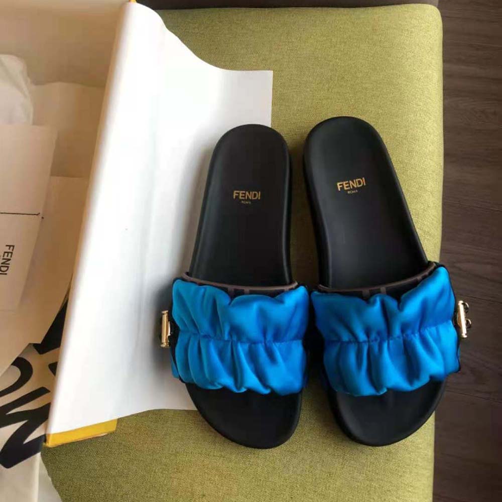 Close-up detail of Fendi vertigo logo on Light Blue Satin Slides