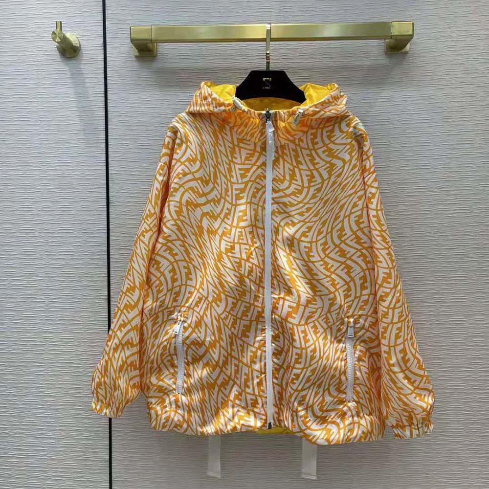 Close-up of signature Fendi logo hardware on yellow nylon jacket