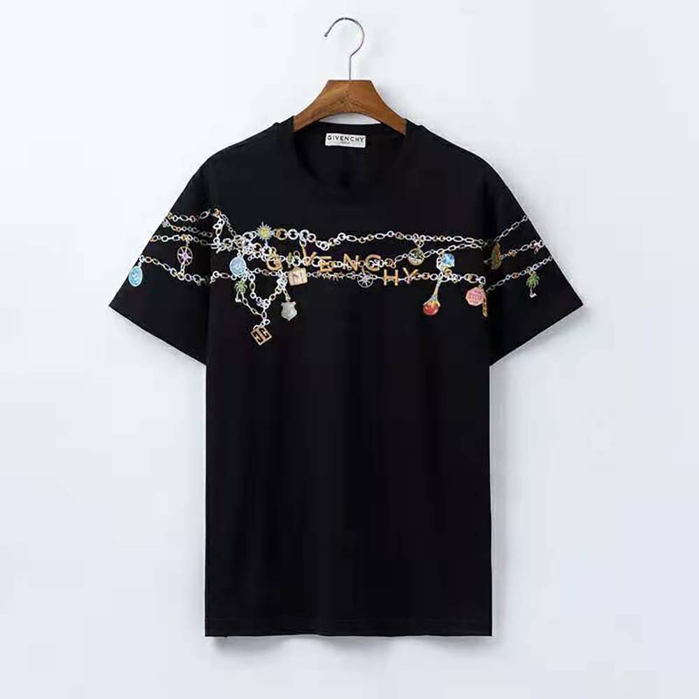 Close-up of Givenchy charm hardware on black T-shirt sleeve