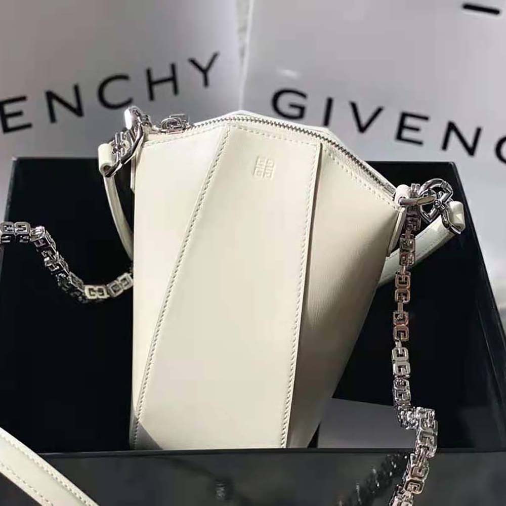 Side view showing compact vertical silhouette of Givenchy white leather bag