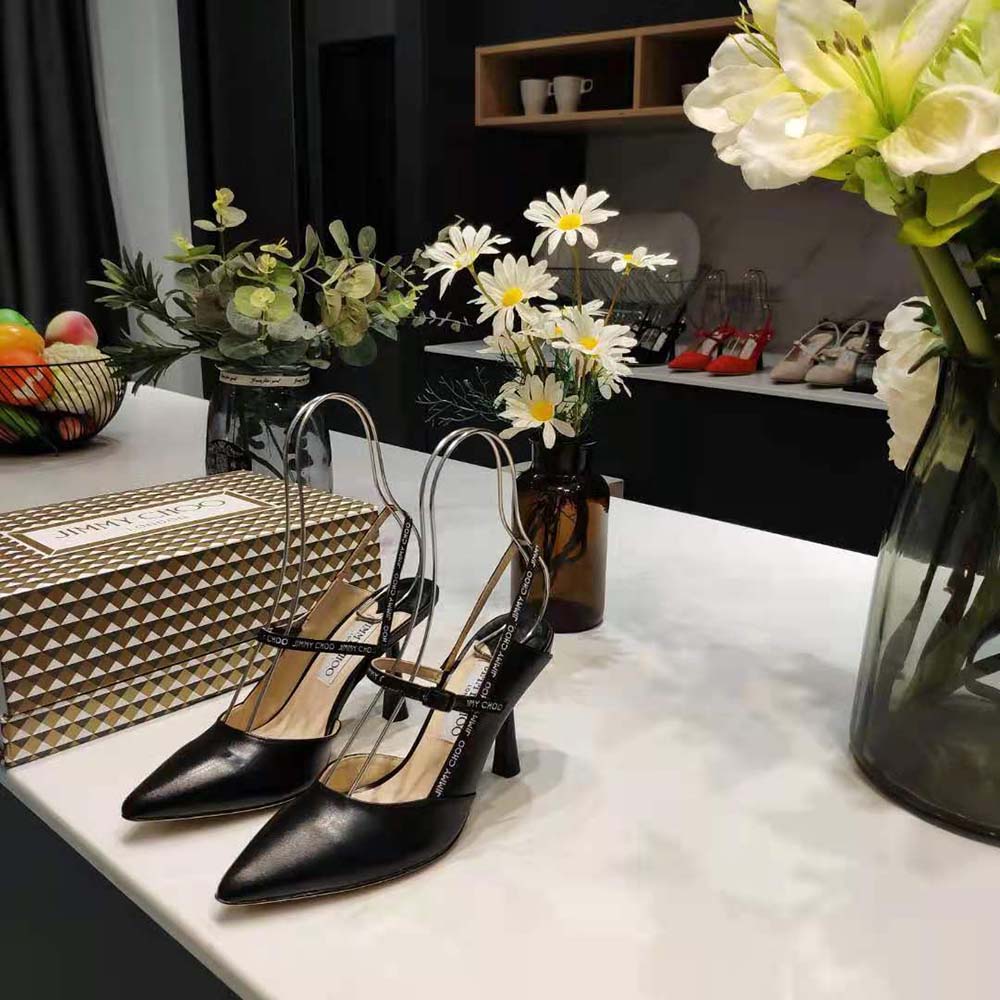 Close-up detail of logo-woven ribbon on Jimmy Choo Ray 65 black pumps