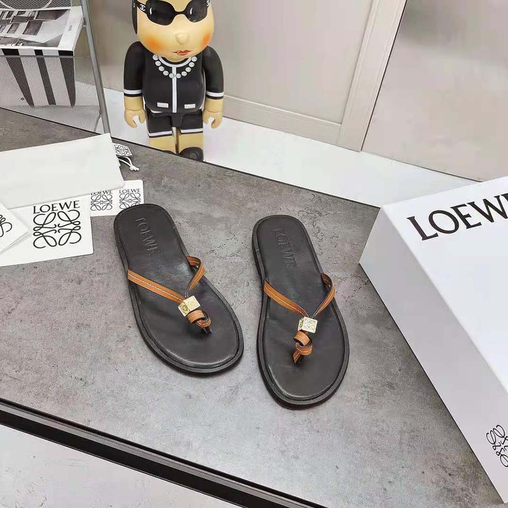 Close-up of black calfskin and embossed Loewe logo on flip flop