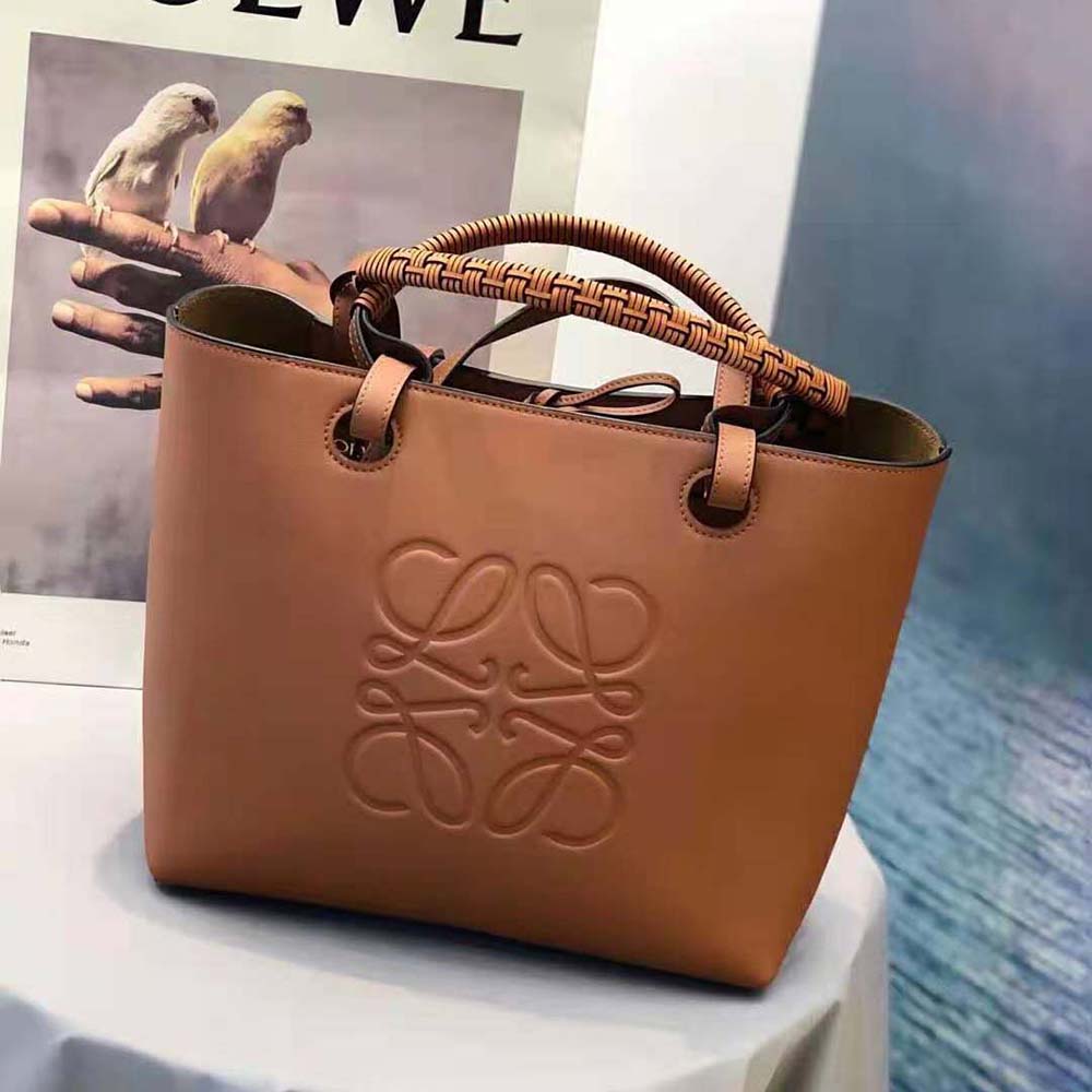 Close-up detail of Loewe signature anagram hardware on brown tote