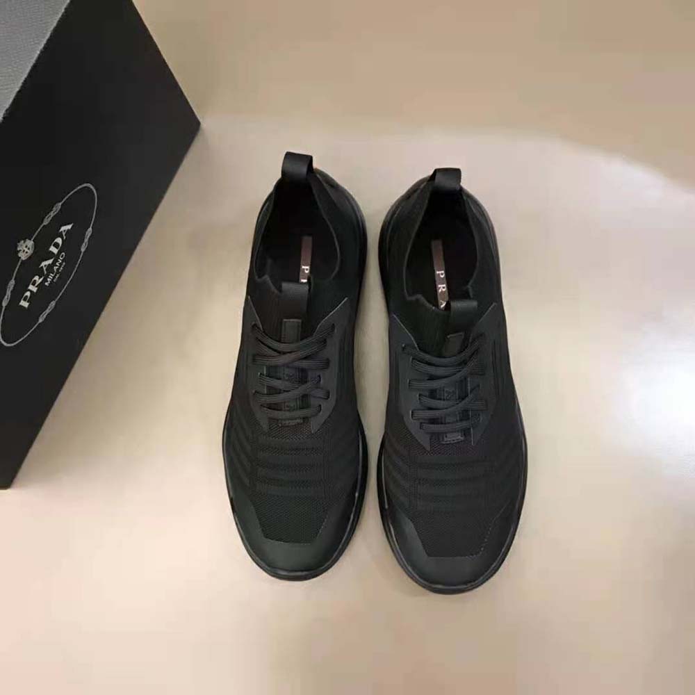 Close-up of black technical fabric and embossed Prada logo detail