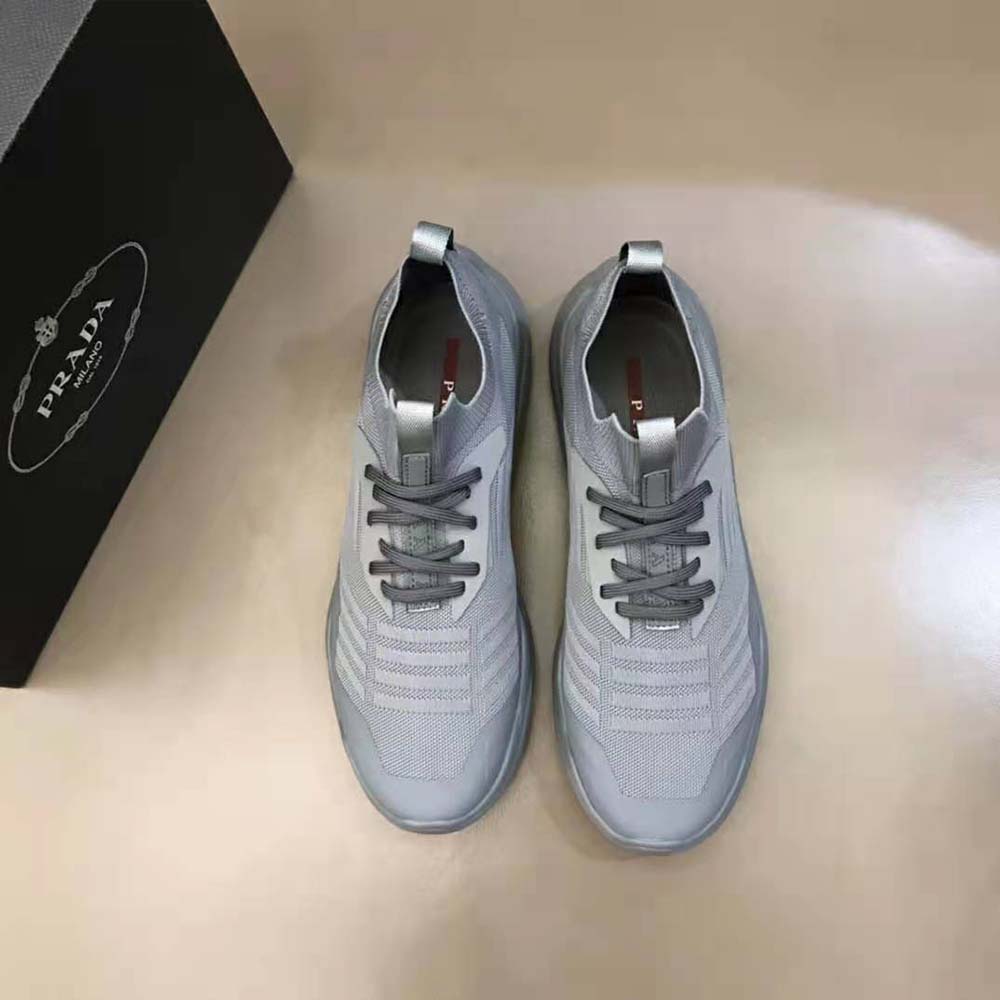 Close-up of gray technical fabric and lace detail on Prada sneakers
