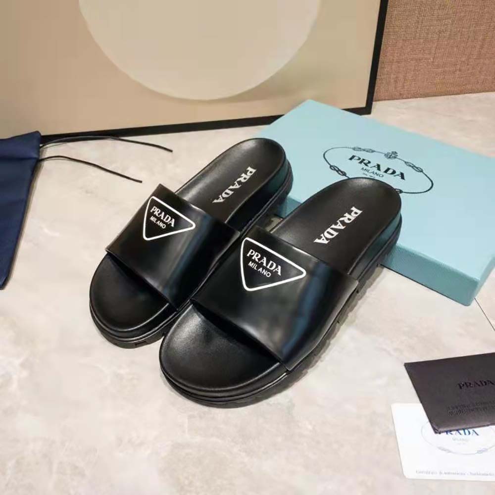 Front angle showing sleek silhouette of Prada Women Leather Slides