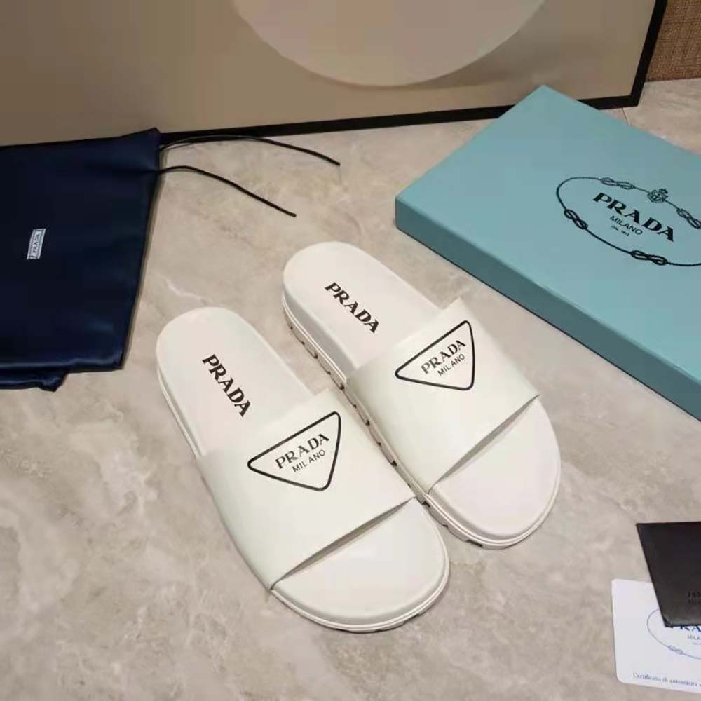 Close-up of white leather and Prada embossing on Women Leather Slides