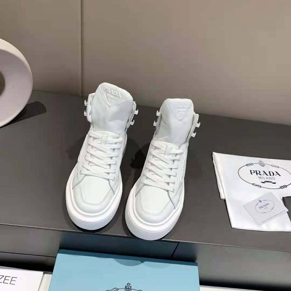 Overhead angle showcasing white nylon texture and lacing of Prada sneakers