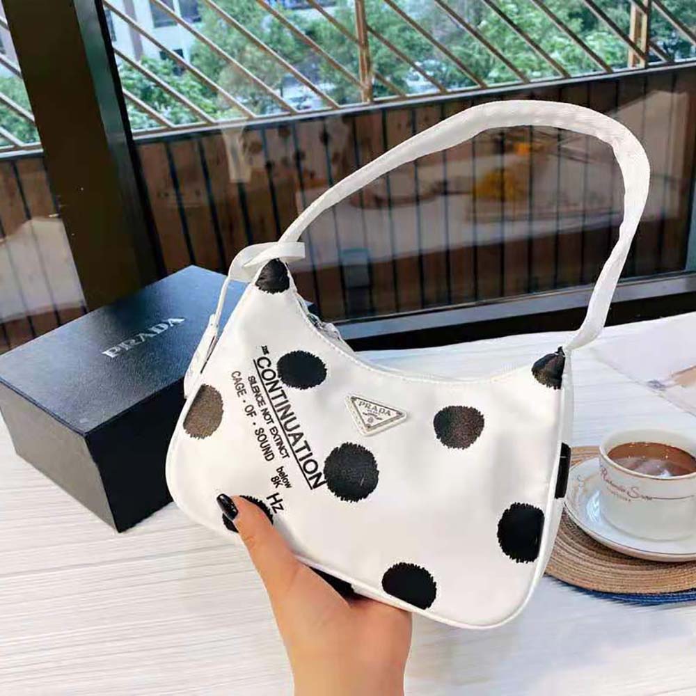 Side angle showing zip closure and strap on Prada mini-bag