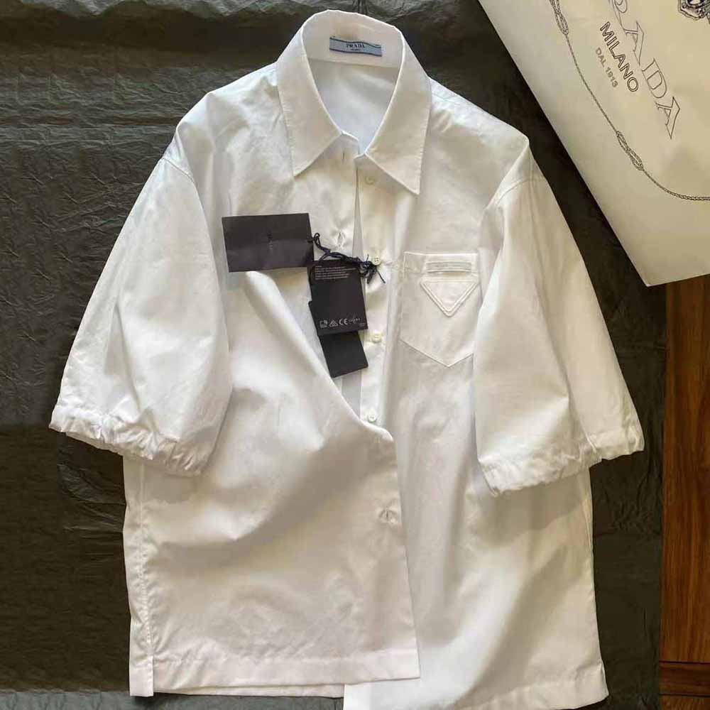 Side angle showing silhouette and signature puff sleeves of Prada blouse