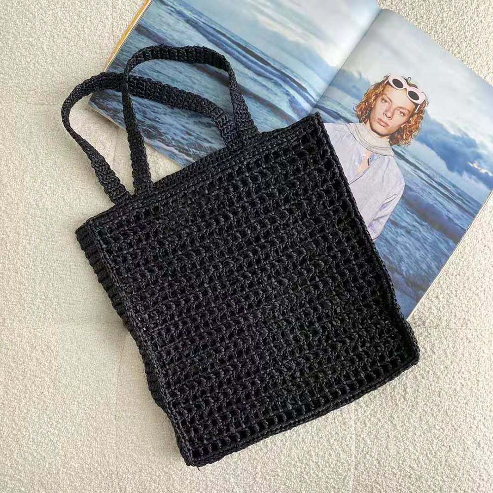 Side angle highlighting tote silhouette and leather trims of Prada bag