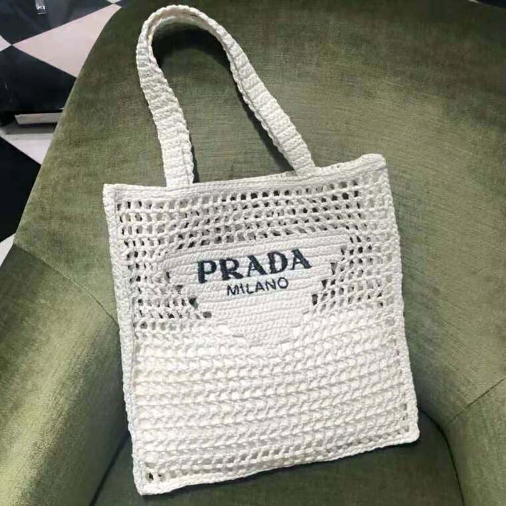 Close-up of gold-tone hardware on Prada Women Raffia Tote Bag-White