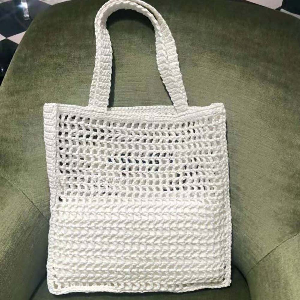 Side angle showing silhouette of Prada Women Raffia Tote Bag-White