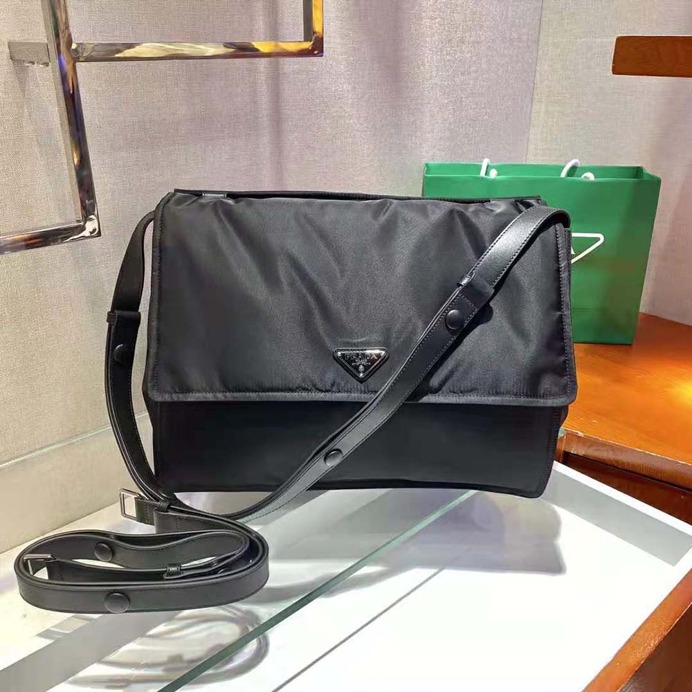 Close-up of Prada signature triangle metal plaque on Re-Nylon bag