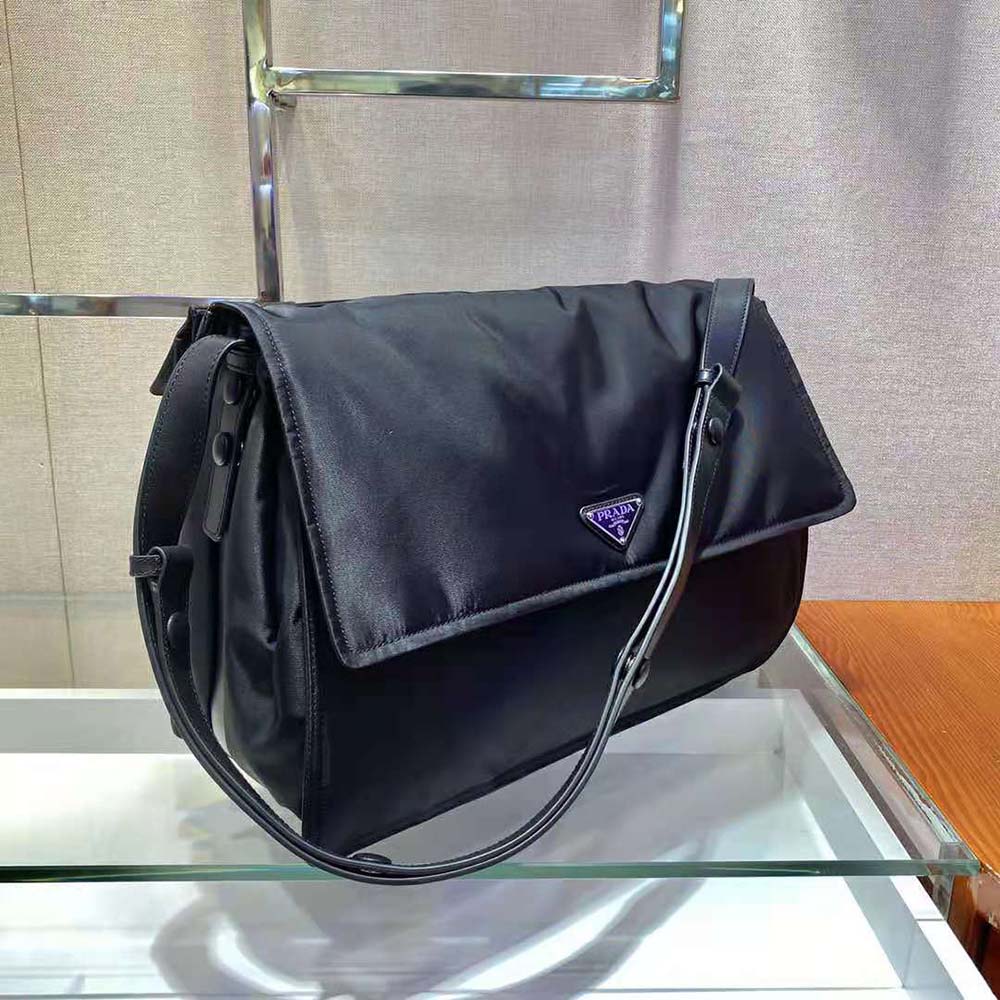 Side angle showing padded shoulder strap of Prada Women Re-Nylon bag