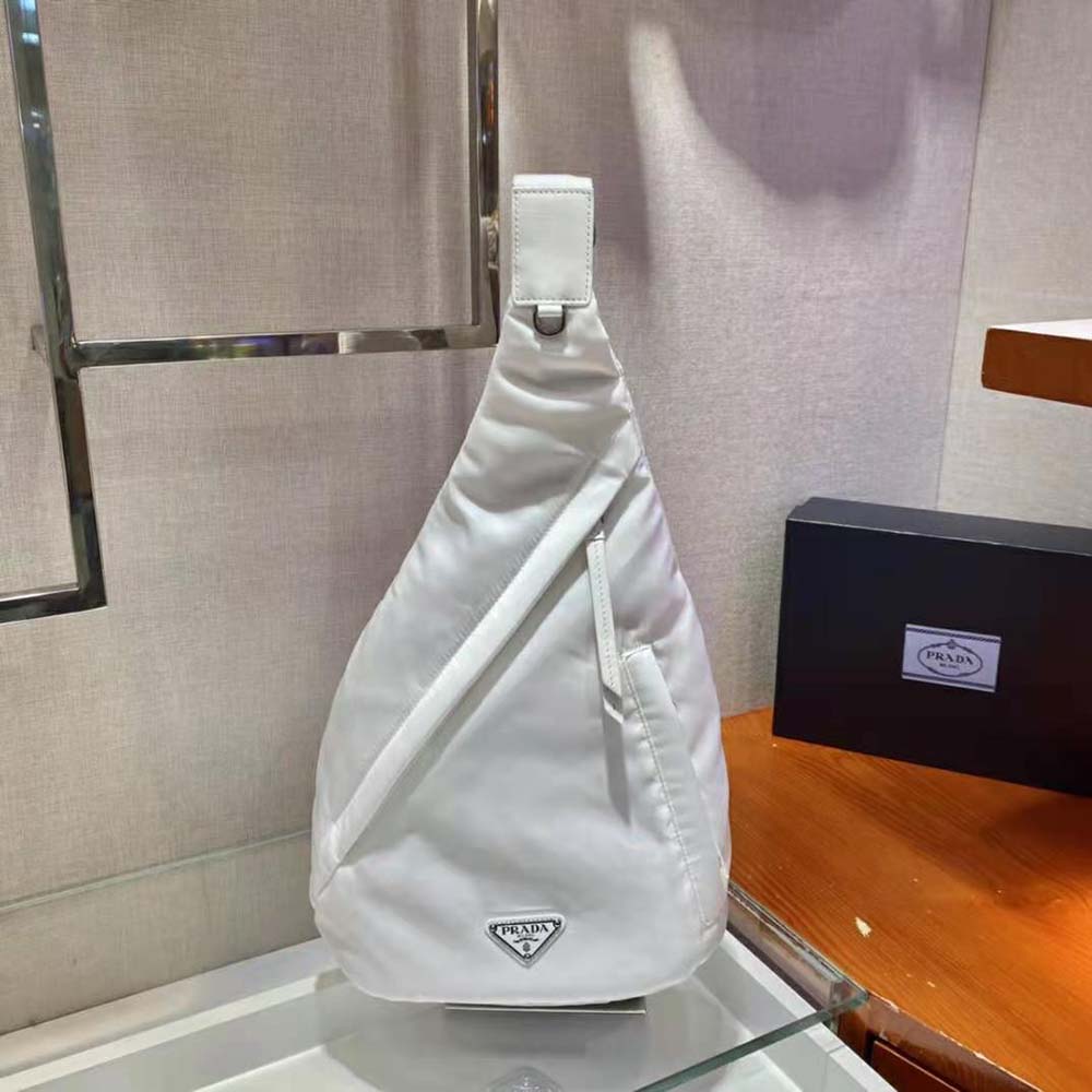 Close-up of white leather trimming and silver hardware on Prada backpack