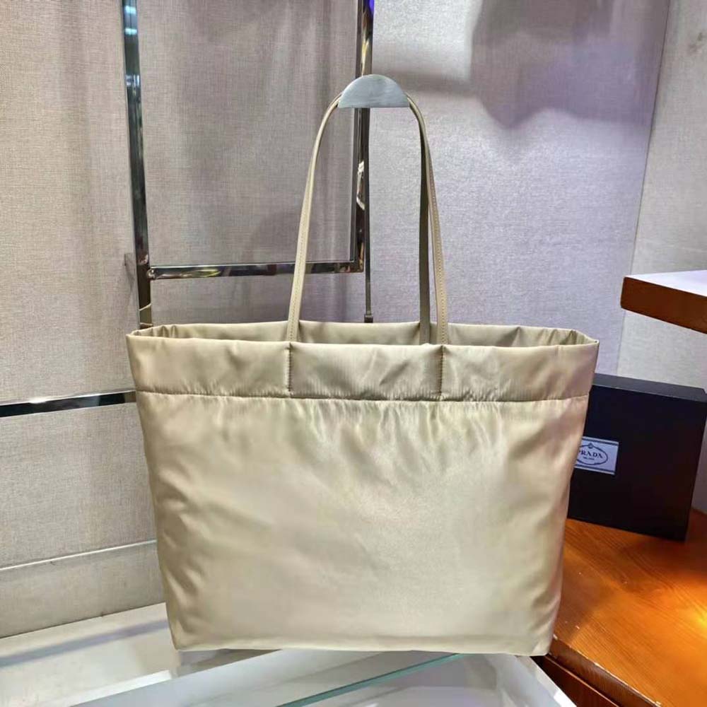 Side angle showing spacious interior and gold hardware of Prada tote