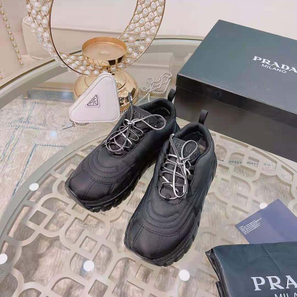 Close-up on Prada logo plaque of Rush Gabardine Re-Nylon Sneakers