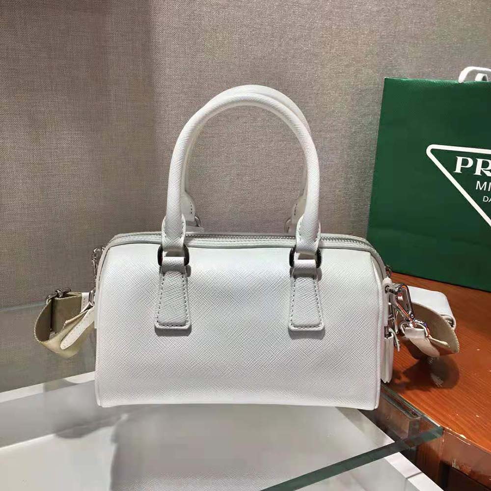 Side angle showing silver hardware on Prada Women Saffiano Leather Top-handle Bag-White