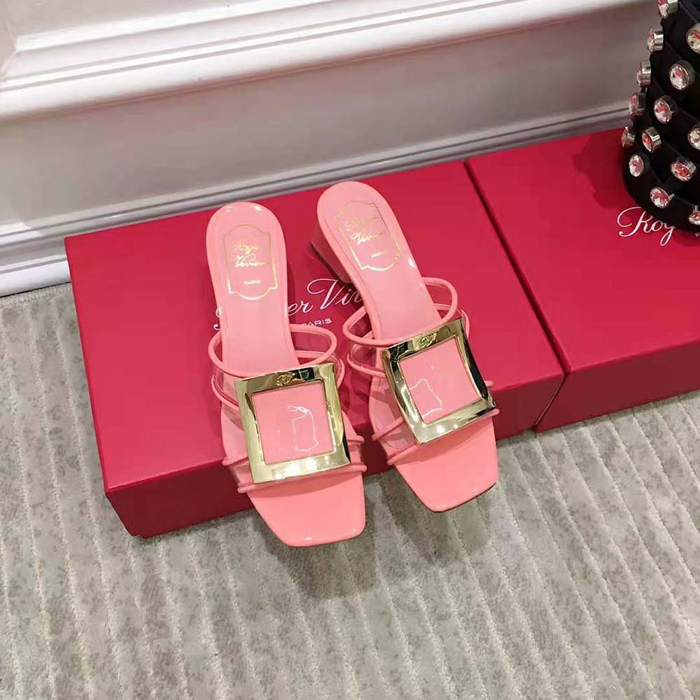 Close-up on glossy pink PVC and metal buckle of Roger Vivier mules