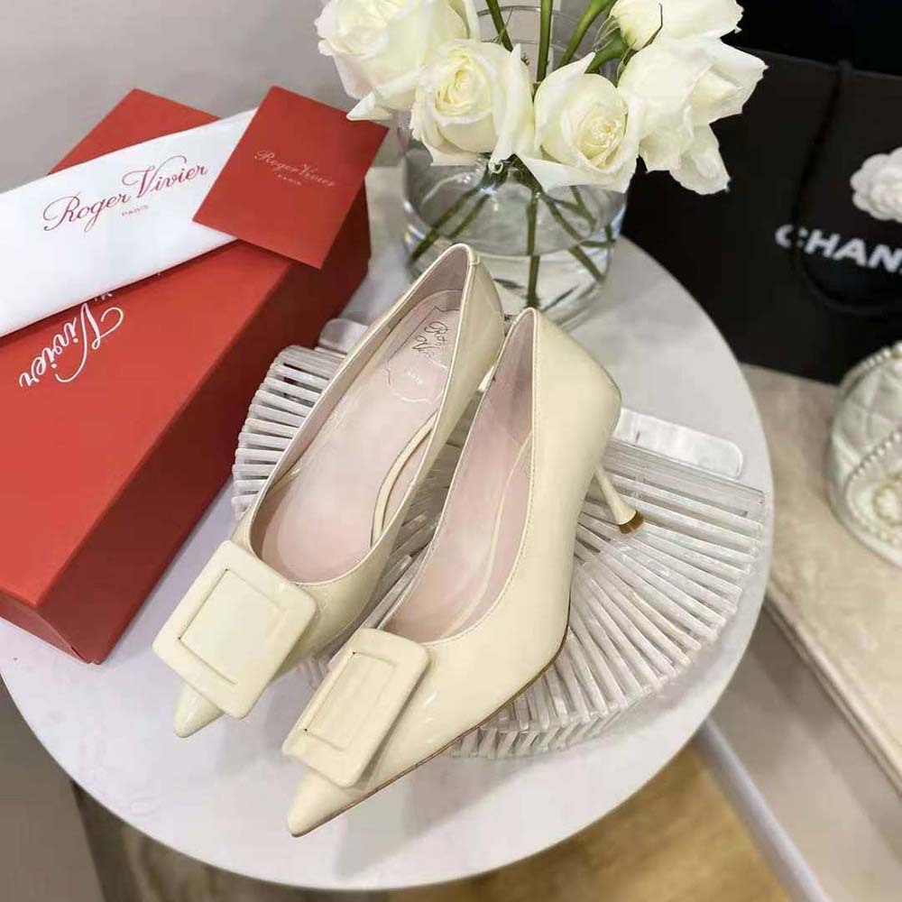 Overhead shot highlighting glossy white patent leather on Roger Vivier pumps