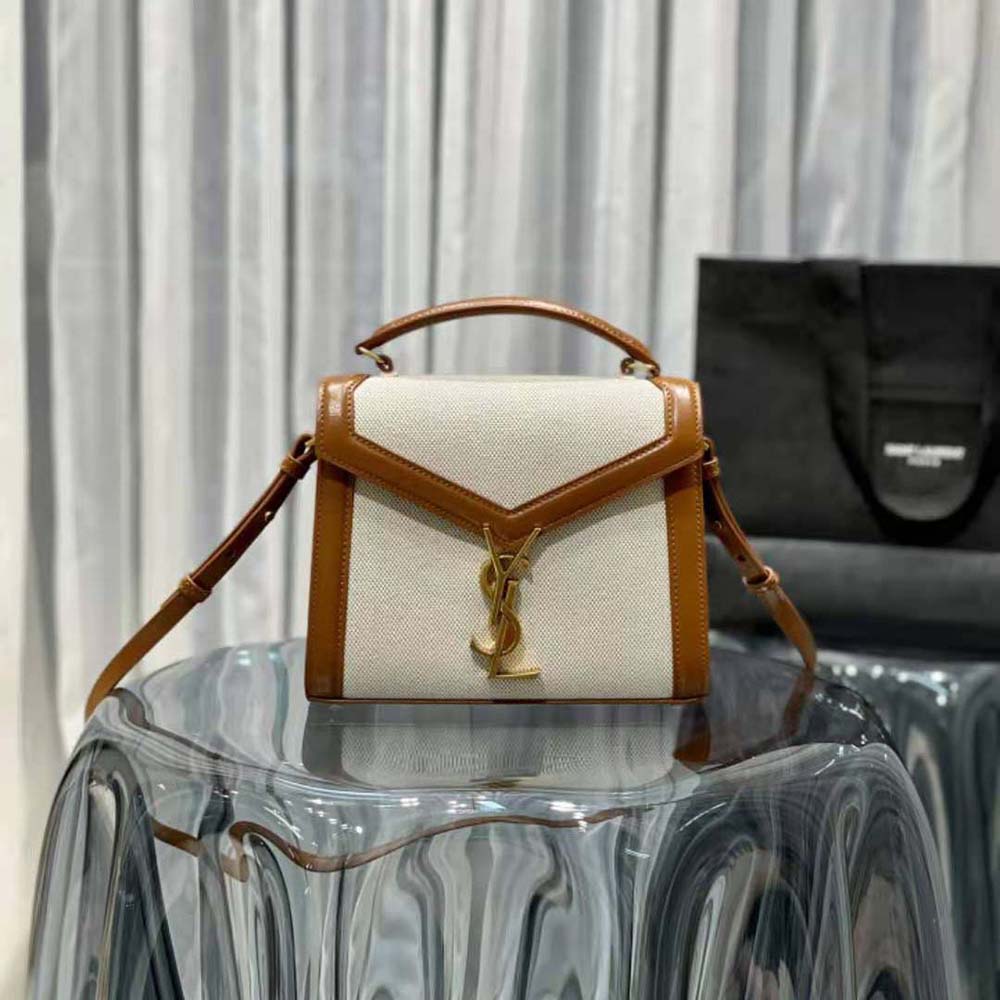 Close-up of gold-tone YSL logo on Saint Laurent YSL Women Cassandra Mini Top Handle Bag