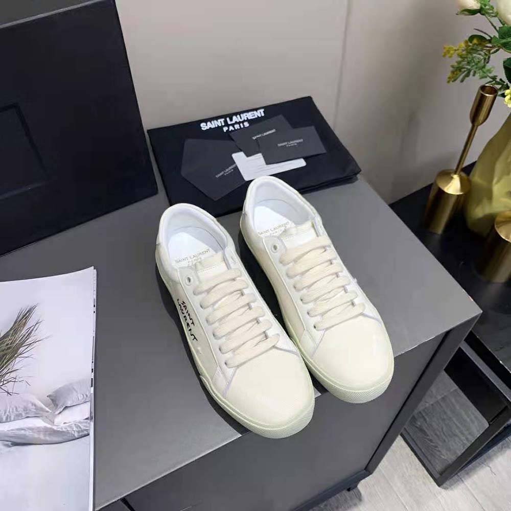 Close-up of embroidered Saint Laurent logo on white sneakers