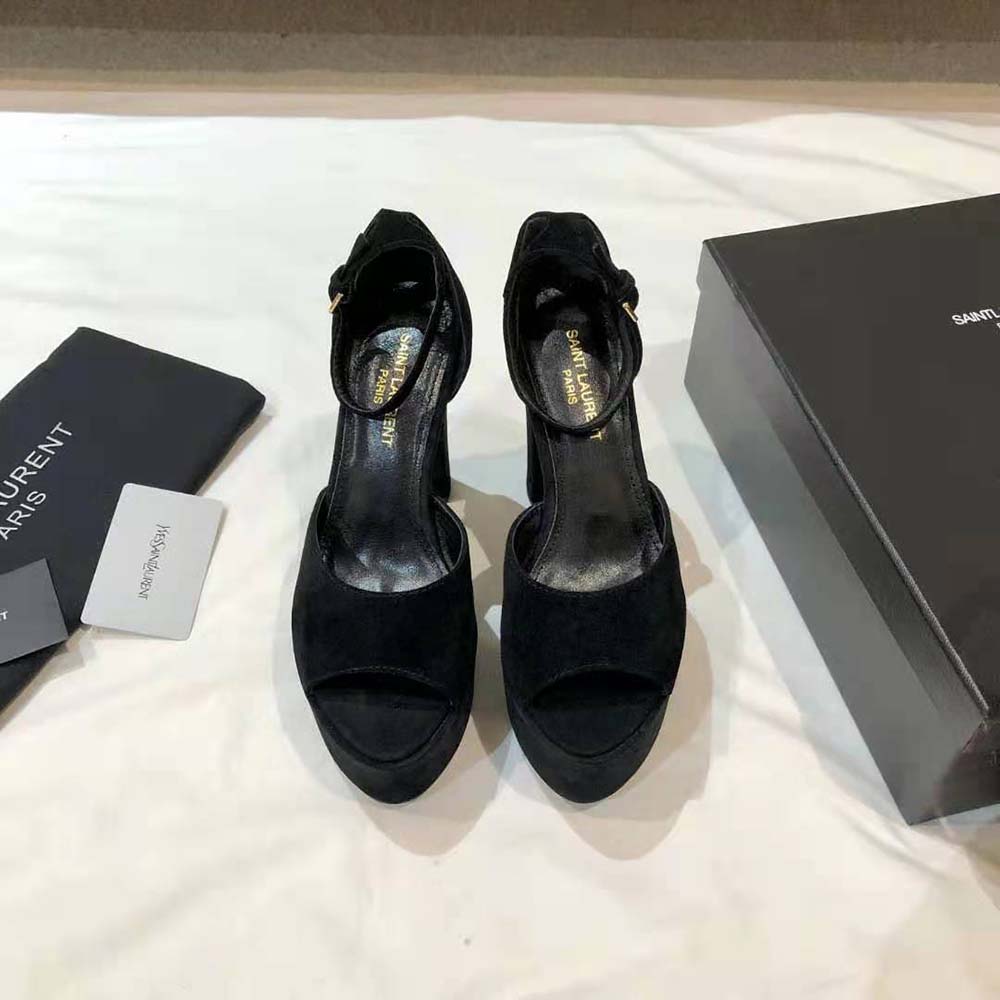Close-up of gold YSL logo hardware on Jodie Platform Sandals