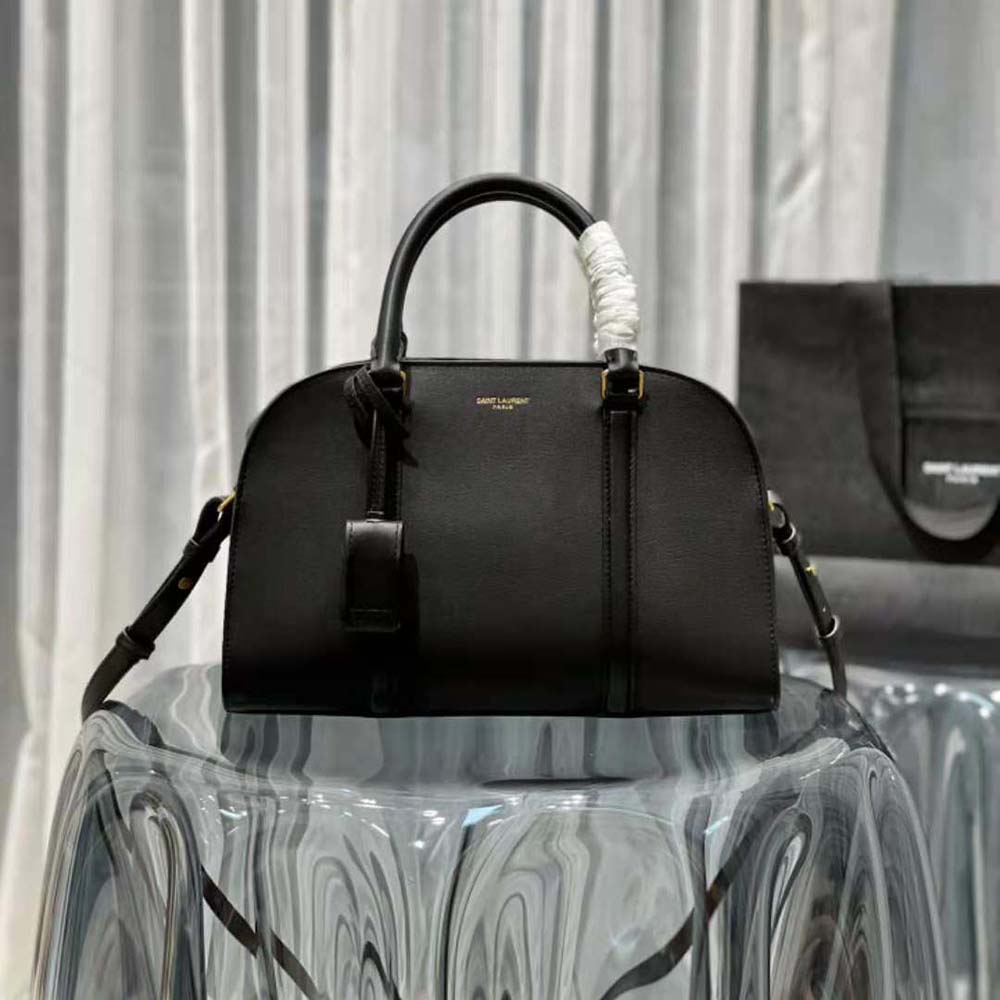 Close-up of gold-tone YSL lock hardware on Baby Duffle in black leather