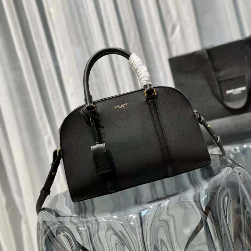 Side angle showing compact silhouette of Saint Laurent YSL Women Lock Baby Duffle