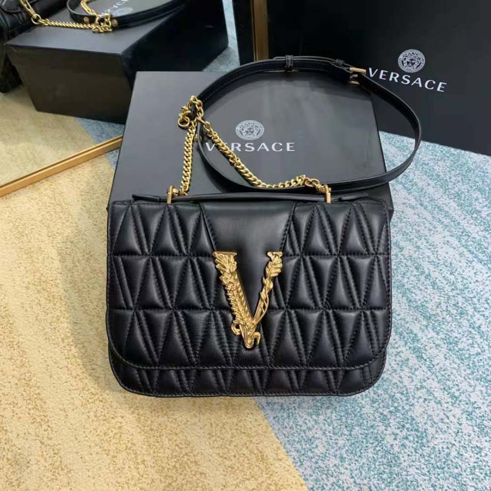 Close-up of gold Medusa hardware on Versace Women Virtus Quilted Shoulder Bag-Black