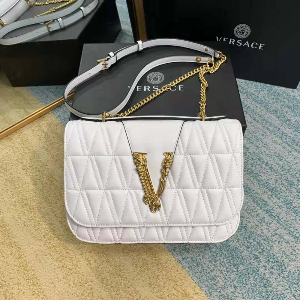 Close-up of gold Medusa hardware on Versace Women Virtus Quilted Shoulder Bag-White