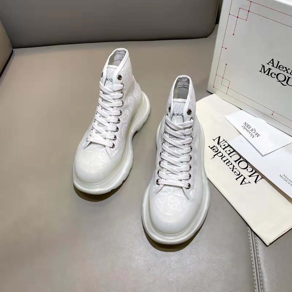 Close-up of white leather and signature tread sole on Alexander Mcqueen boot