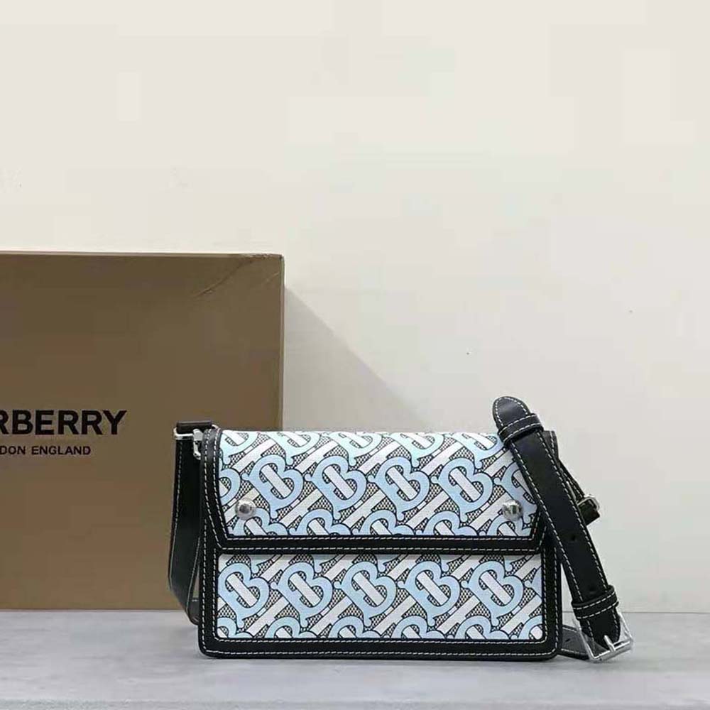 Close-up of blue leather trim and brass hardware on Burberry crossbody bag