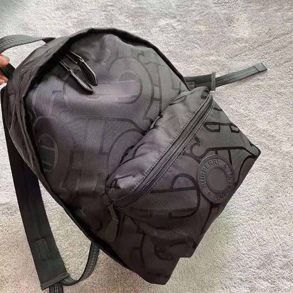 Side angle showing adjustable straps on Burberry Men Monogram Recycled Polyester Jacquard Backpack-Black