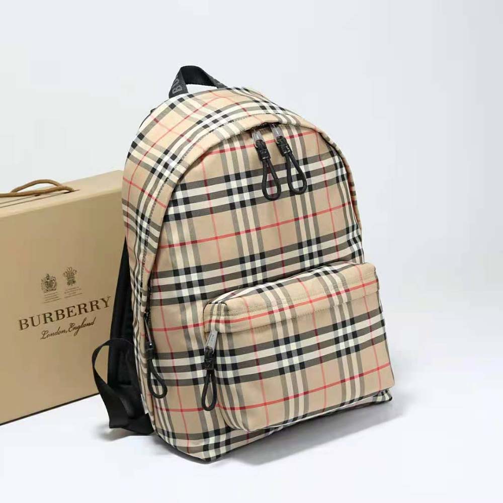 Close-up of beige vintage check pattern and leather trim on backpack