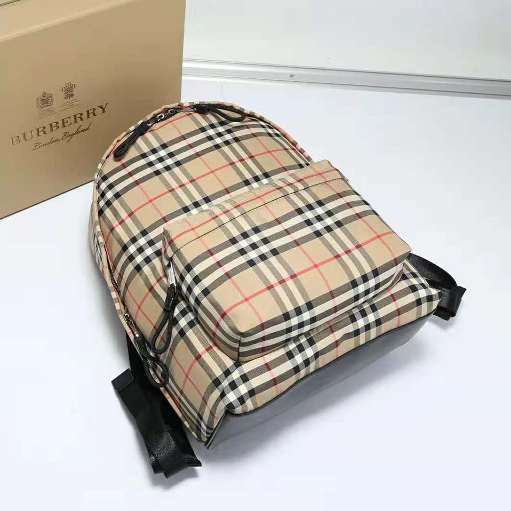 Side angle showing adjustable strap and Burberry logo on backpack