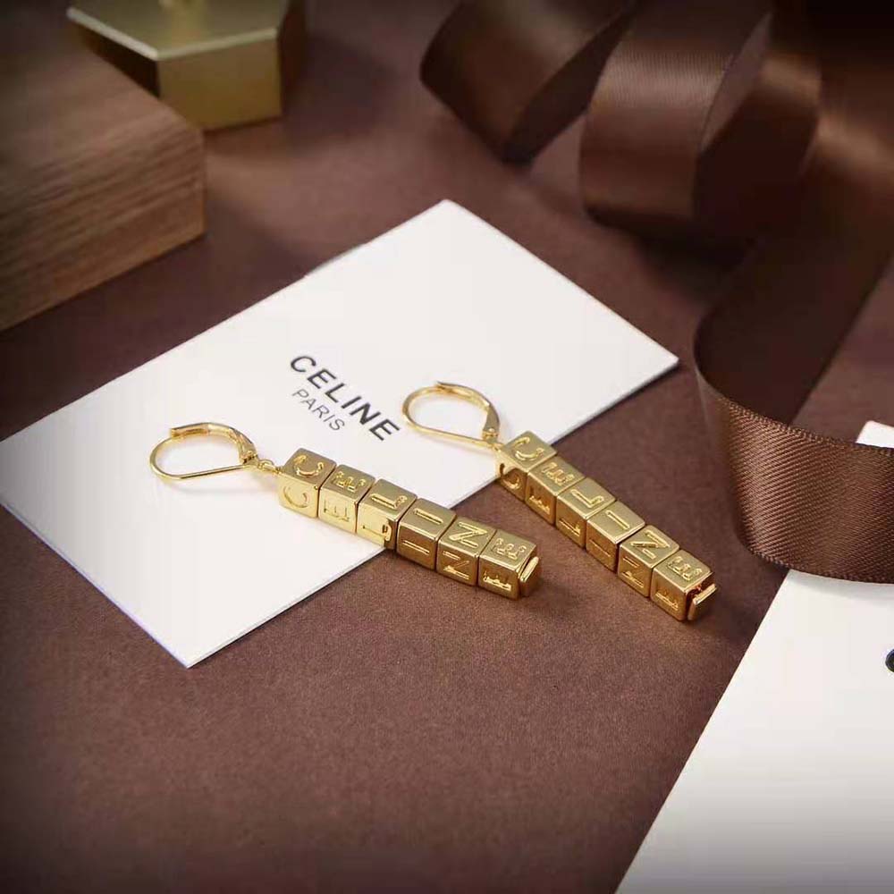 Close-up detail of gold finish on Celine Women Earrings in Brass